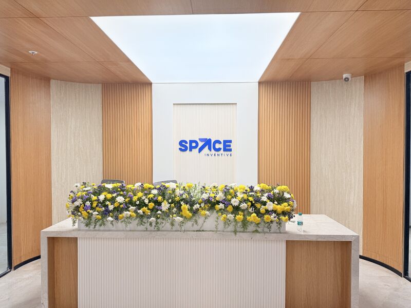 Flowers lining the reception desk at Space Inventive’s capability-center opening