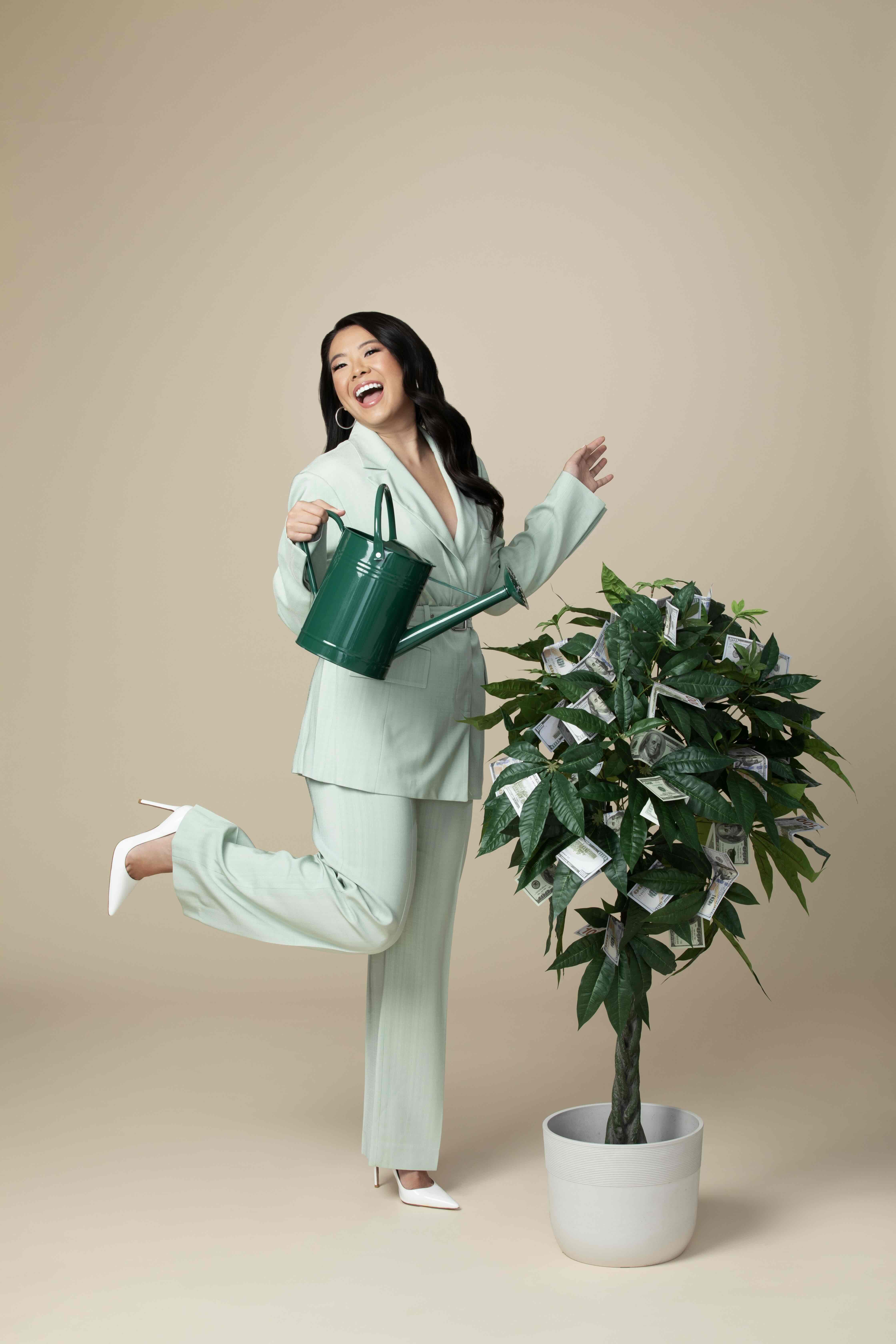 Vivian Tu in a studio portrait with a money tree