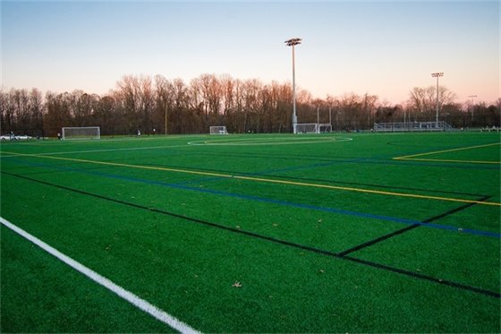 A new green athletic field at dusk, photographed by Vlad Berson in Middletown Township