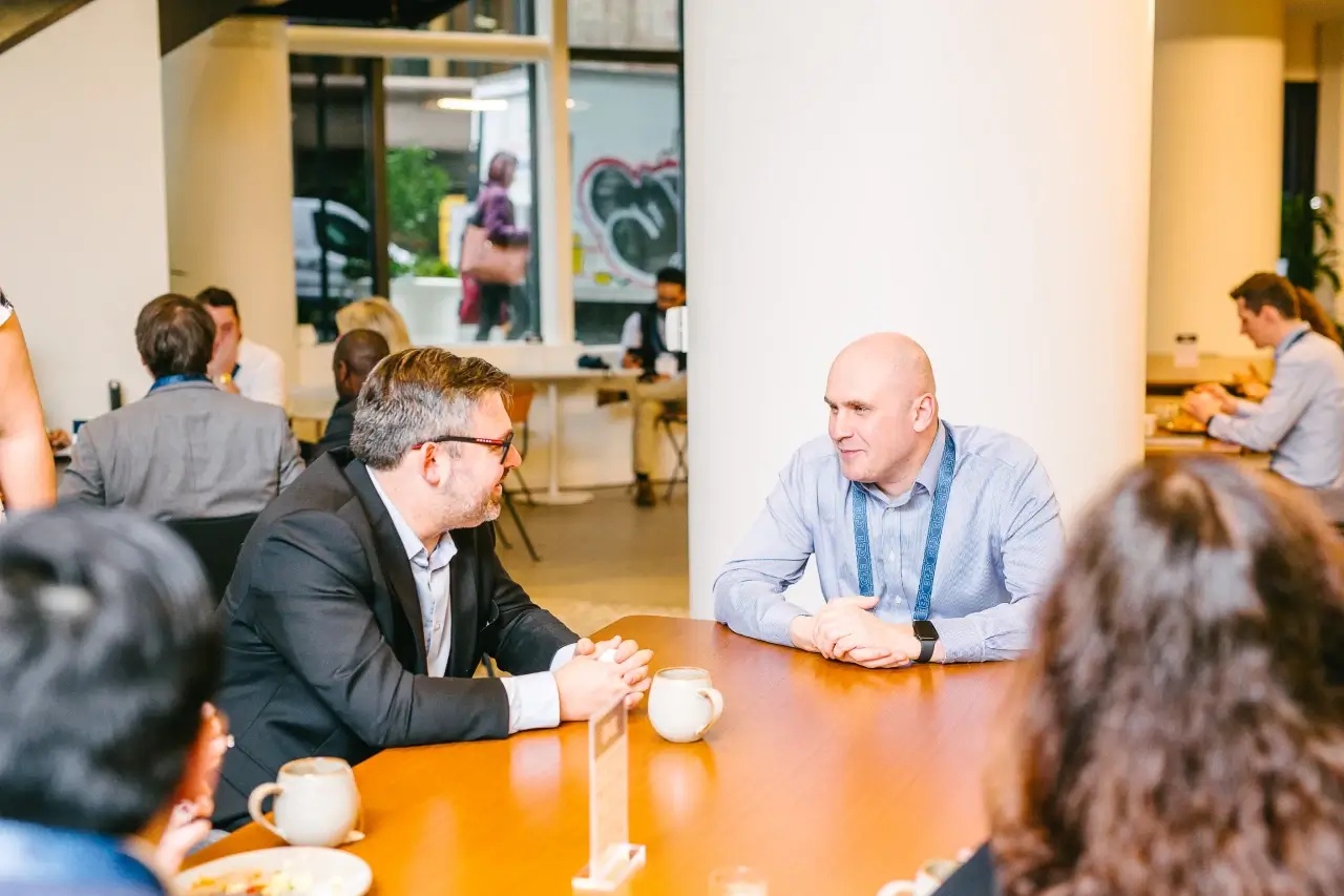 Vlad Medvedovsky seated at a table in conversation at the EDGE Summit