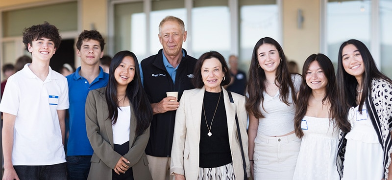 Vlad and Sana Shmunis standing with six JFCS summer interns