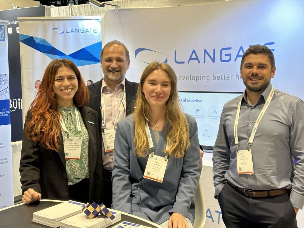 Vlad Vakser and three colleagues standing together at a Langate exhibition booth