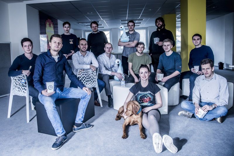 The Smartsupp team gathered in their office, with mugs and a dog
