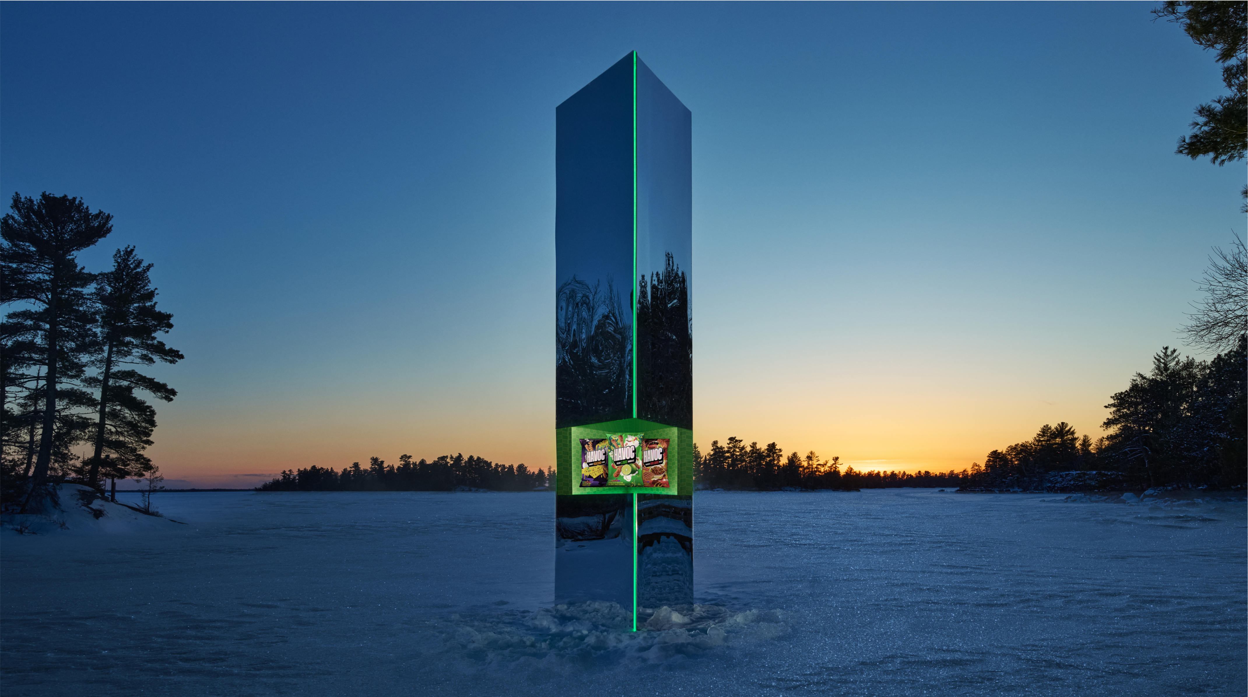 HAVOC’s illuminated monolith stands in a snowy island landscape, with snack bags revealed inside