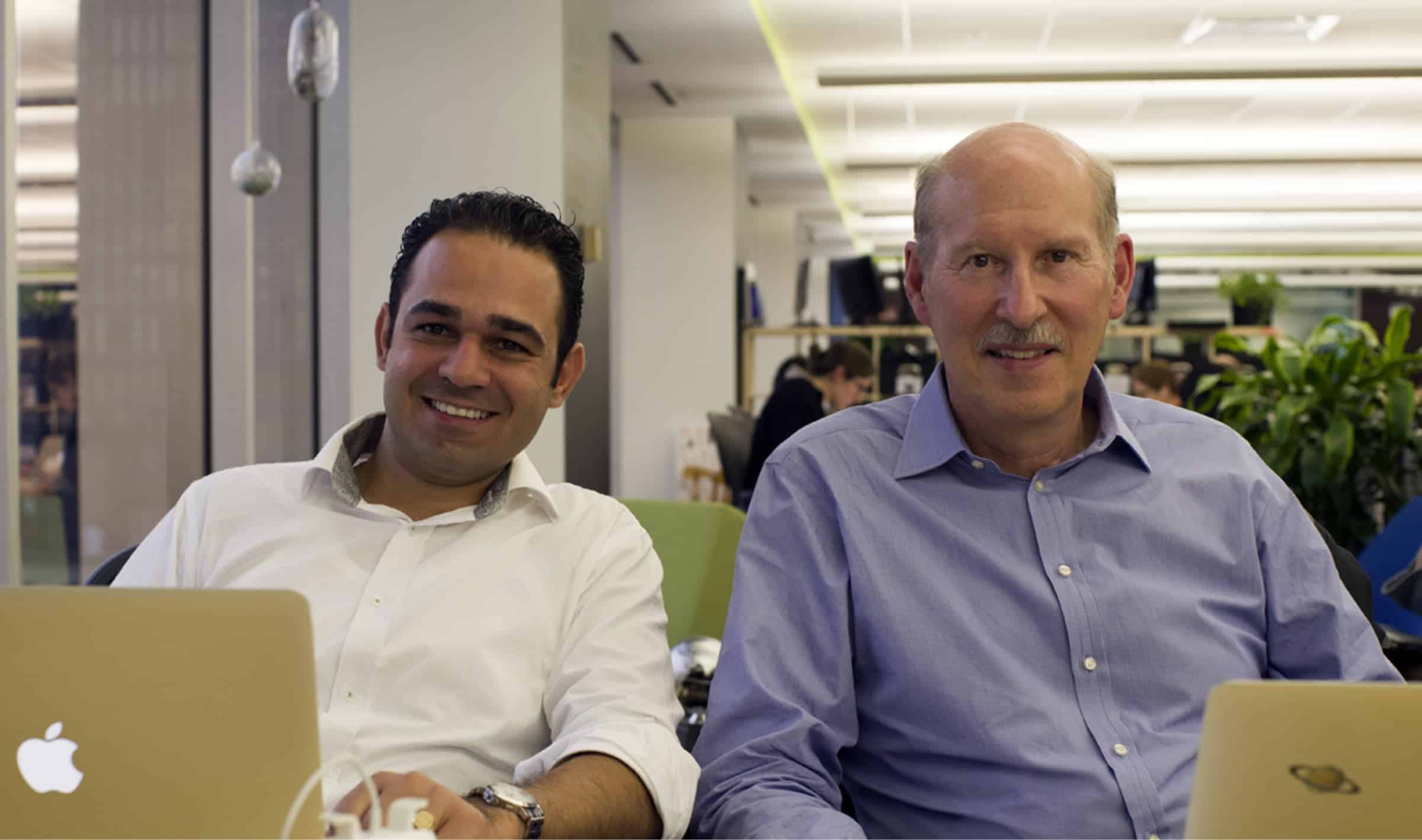 VODA.ai co-founders George Demosthenous and Jim Fitchett seated with laptops