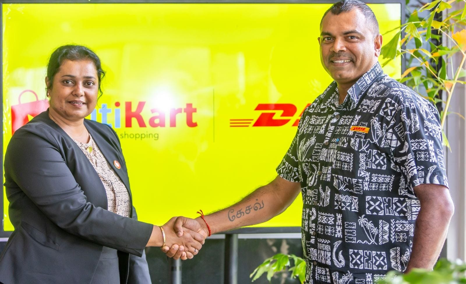 Vodafone and DHL representatives shake hands at the VitiKart international shipping partnership launch