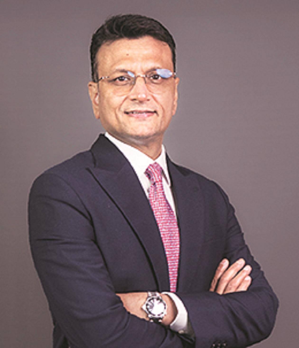 Vodafone Idea chief executive Abhijit Kishore in a dark suit and red tie