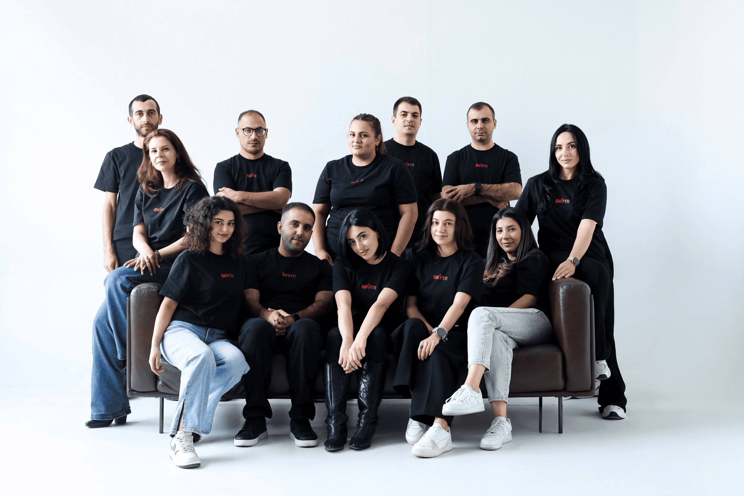 Shiftr team members gathered for a studio group photograph