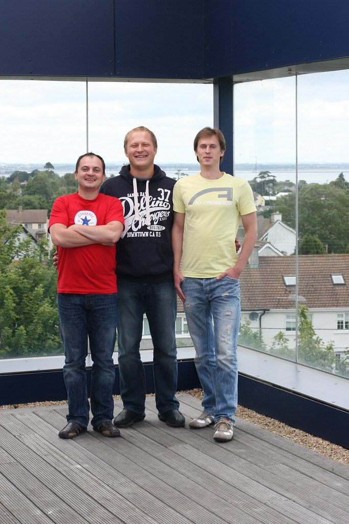 Profitero co-founders Volodymyr Pigrukh, Dmitry Vysotski and Kanstantsin Chernysh standing together on a terrace