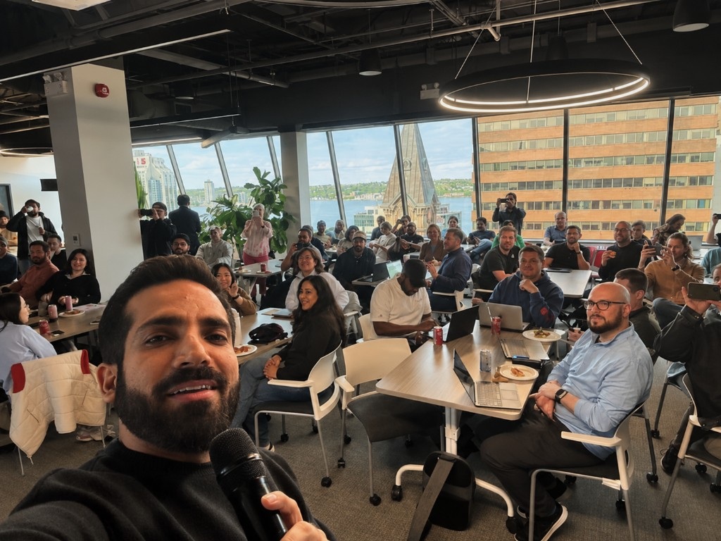 A Volta community gathering with attendees seated at tables overlooking downtown Halifax