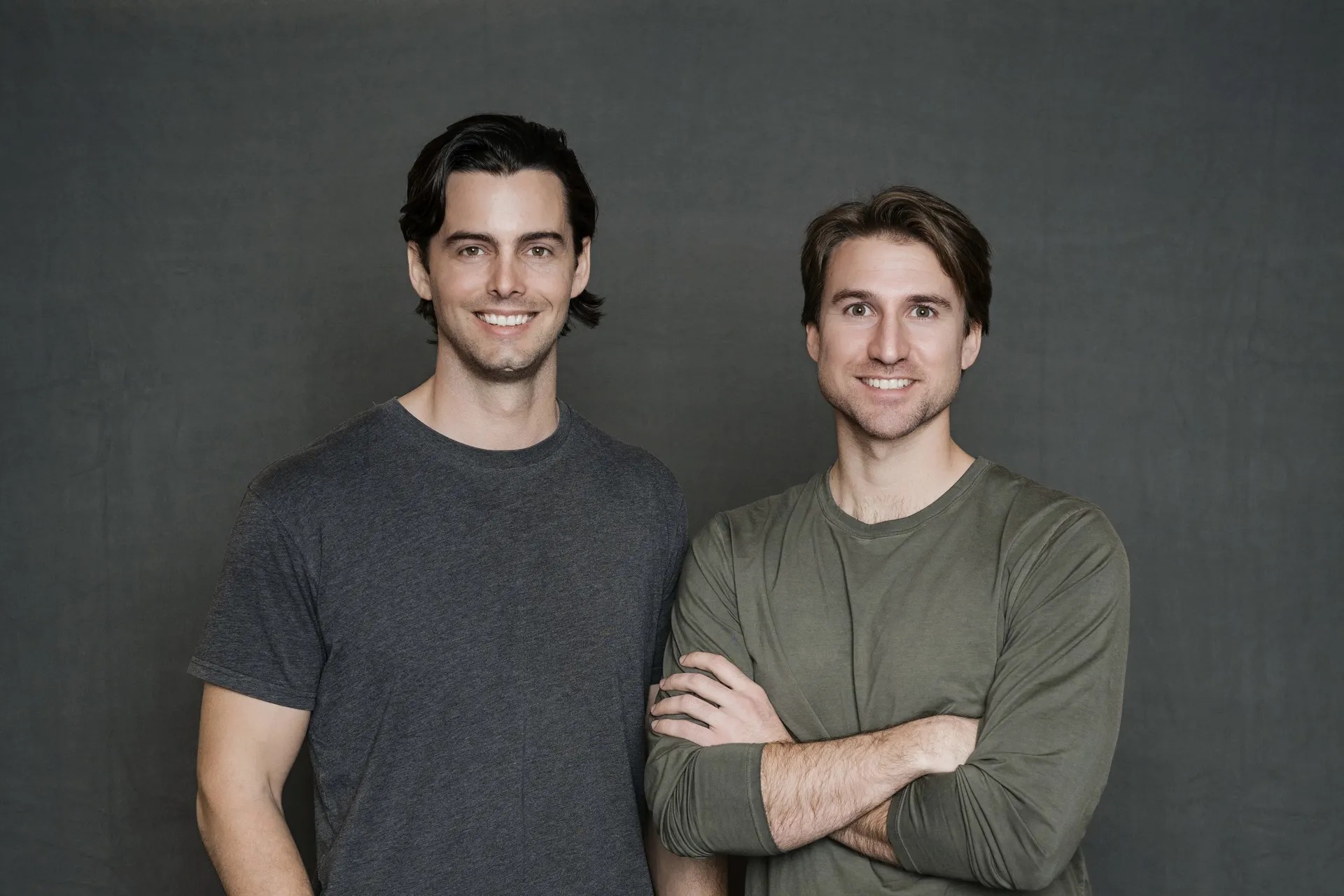 Vooma co-founders Jesse Buckingham and Mike Carter standing against a gray background