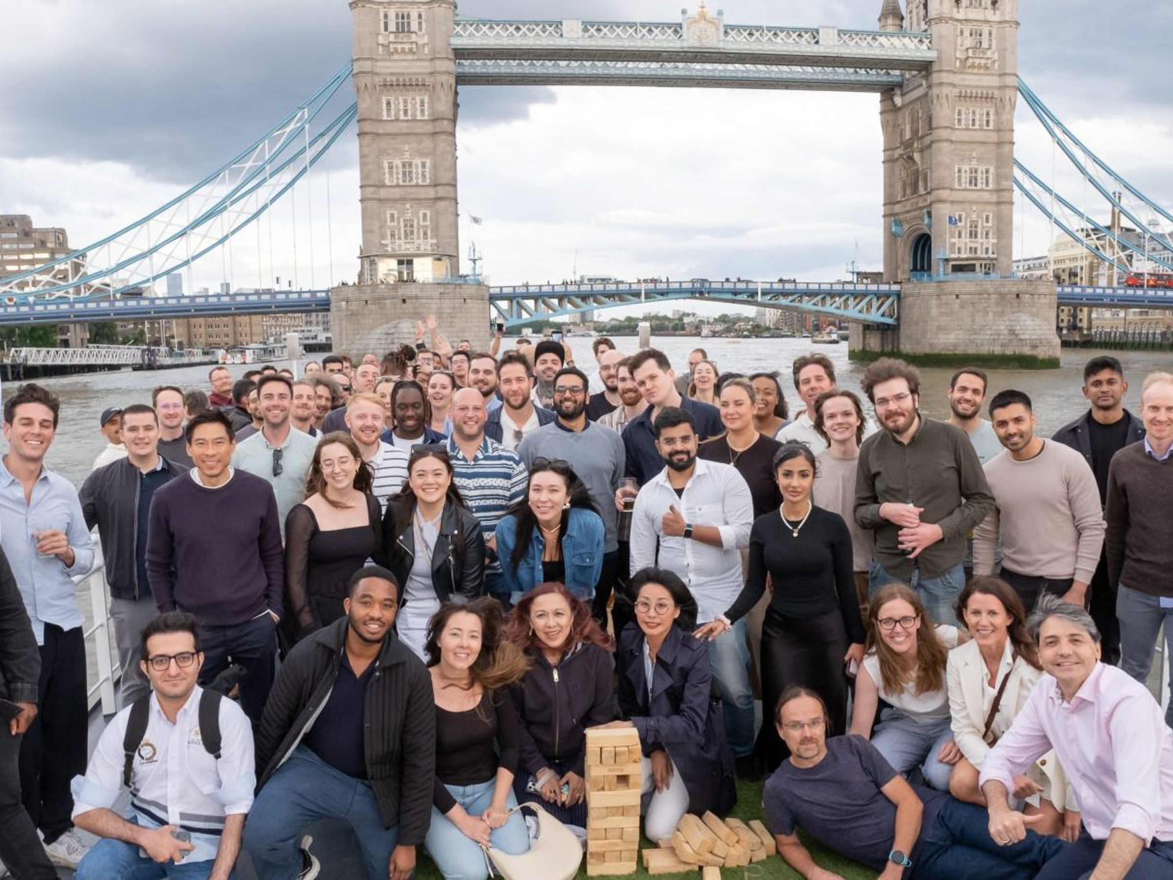Vortexa team gathered aboard a boat near Tower Bridge in London