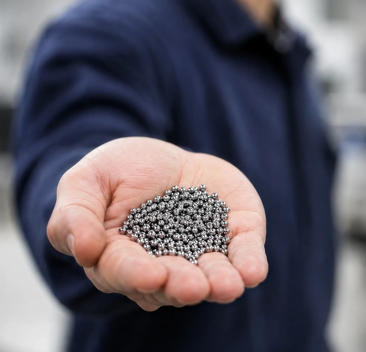 Small aluminum fuel pellets resting in a person's hand