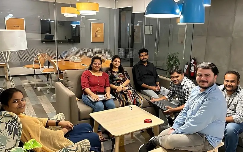 A group pictured together in a vSplash office lounge