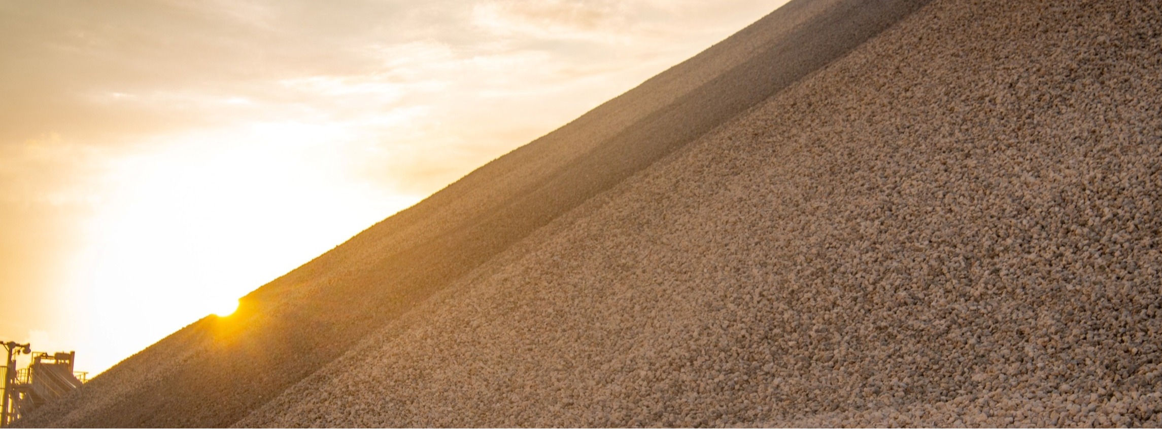 Sunlight falls across an aggregate stockpile at Vulcan’s Miami quarry