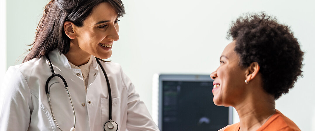 A clinician speaking with a patient in a company promotional photograph