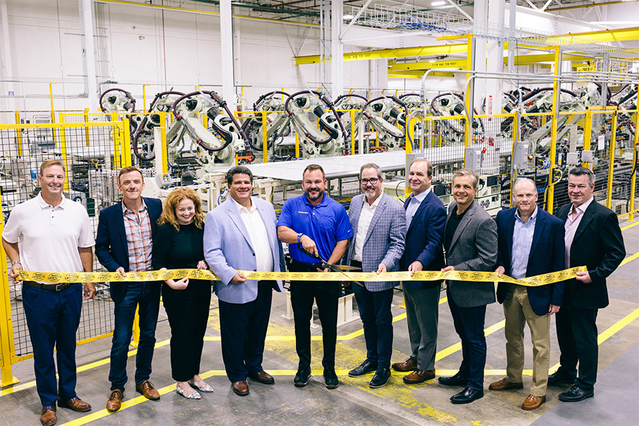 Ribbon-cutting group inside Wabash’s South Plant manufacturing facility
