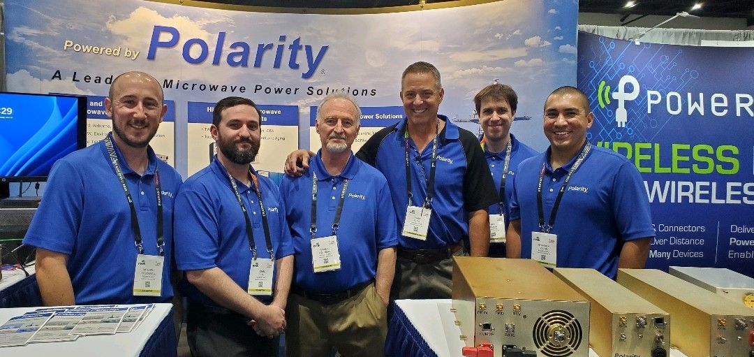 Six members of the Polarity team at an International Microwave Symposium exhibition booth in 2023