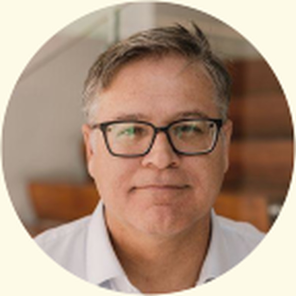 Wade Lagrone in a light shirt and dark-framed glasses
