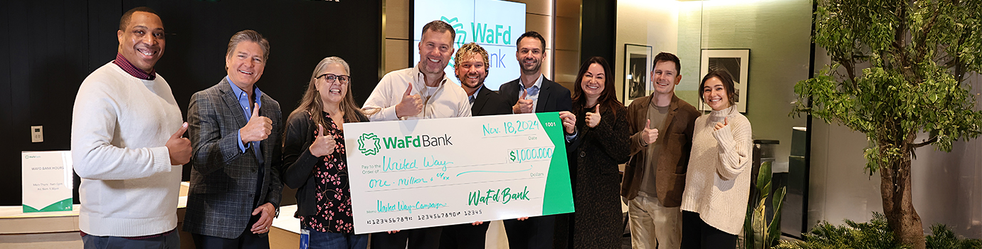 WaFd Bank employees and leadership presenting a one-million-dollar check to United Way