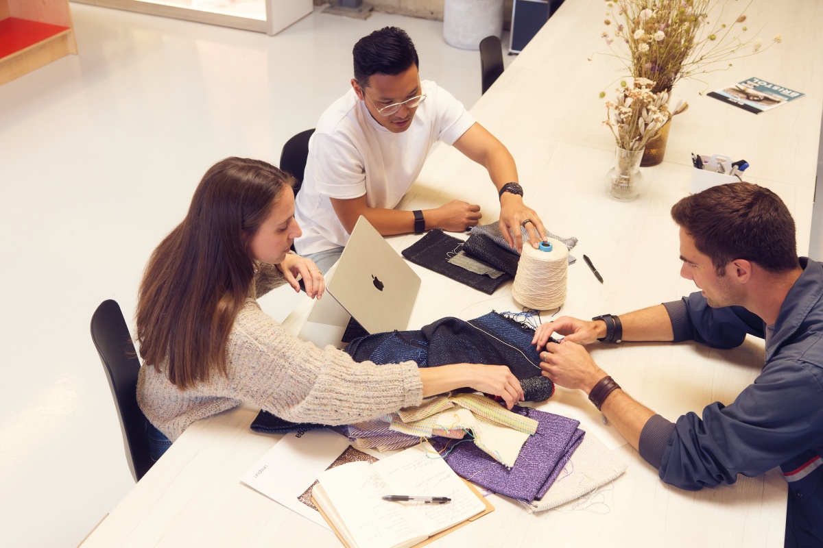 unspun co-founders Beth Esponnette, Walden Lam and Kevin Martin working around a table