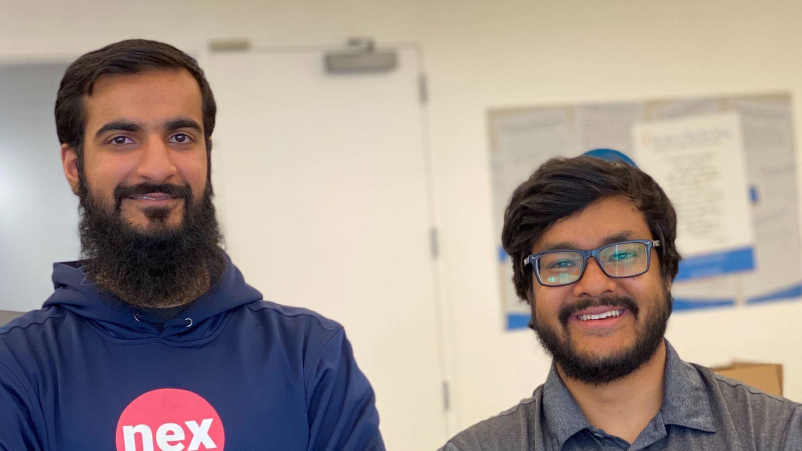 Waleed Asif and Alamin Uddin, the co-founders of NexHealth, standing together in an office