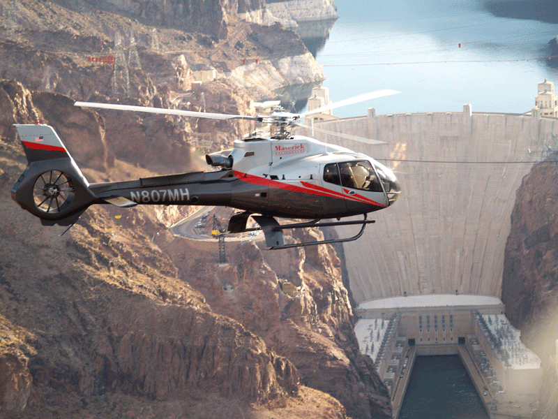 A helicopter flying in front of Hoover Dam during Walt and Company's Escape From Las Vegas launch activation