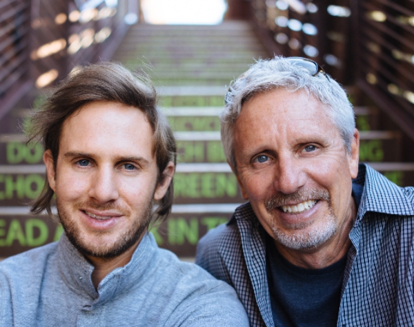 Jeff Cruttenden on the left with his father Walter, both smiling on a stairway.