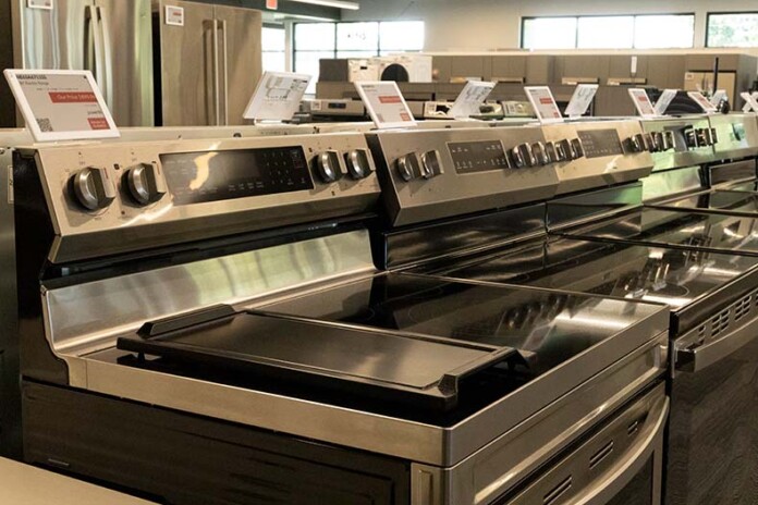 A row of stainless-steel ranges in a Warners' Stellian showroom