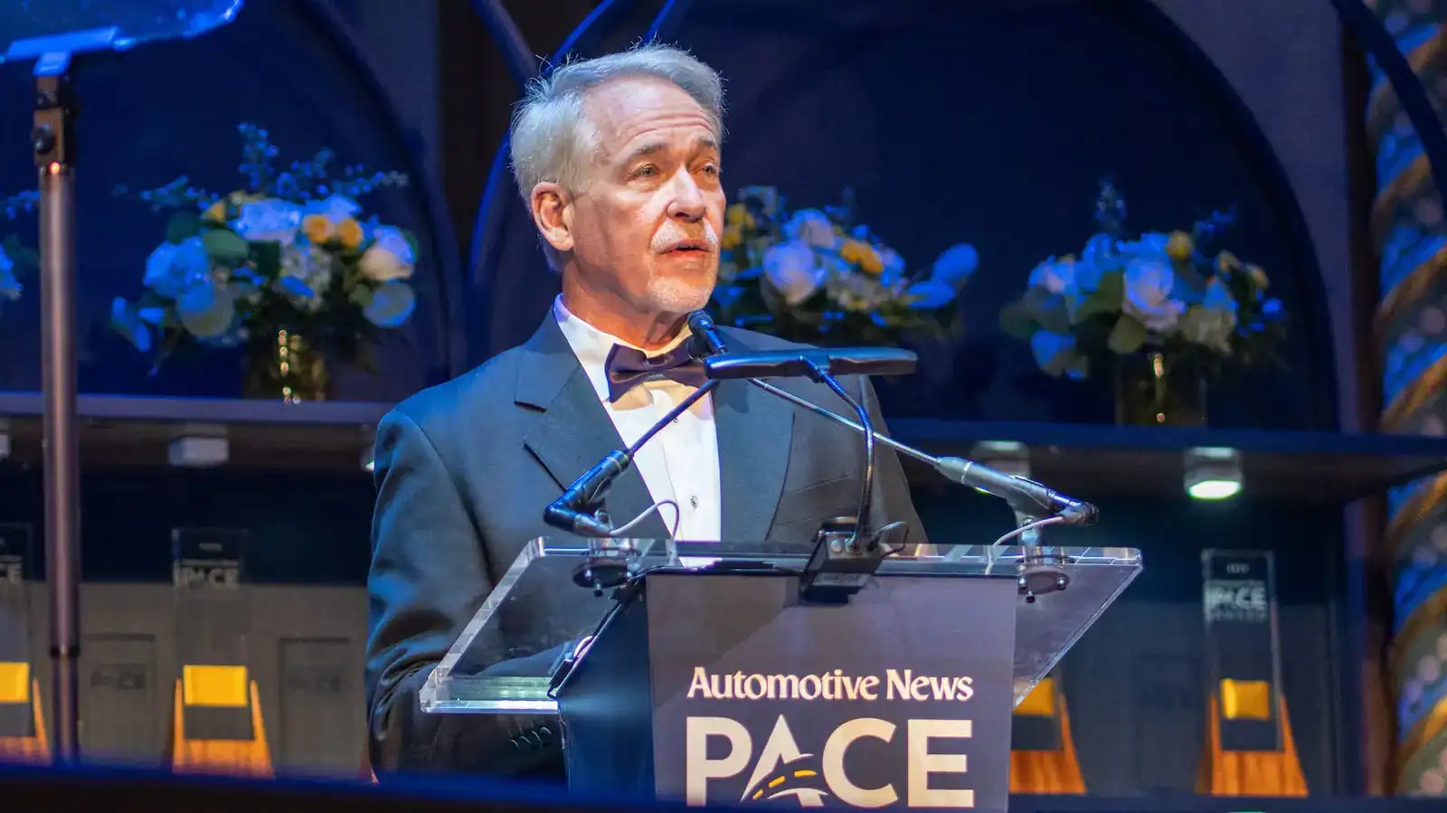 Jim Roche speaking at an Automotive News PACE Award podium