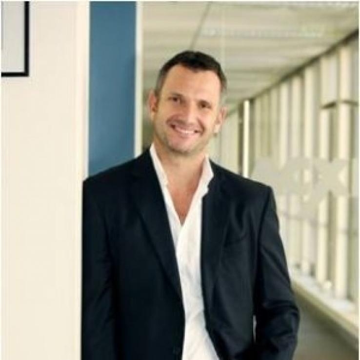 Warren Billington standing in an office corridor, in a press photograph published with his 2014 BrightTag appointment