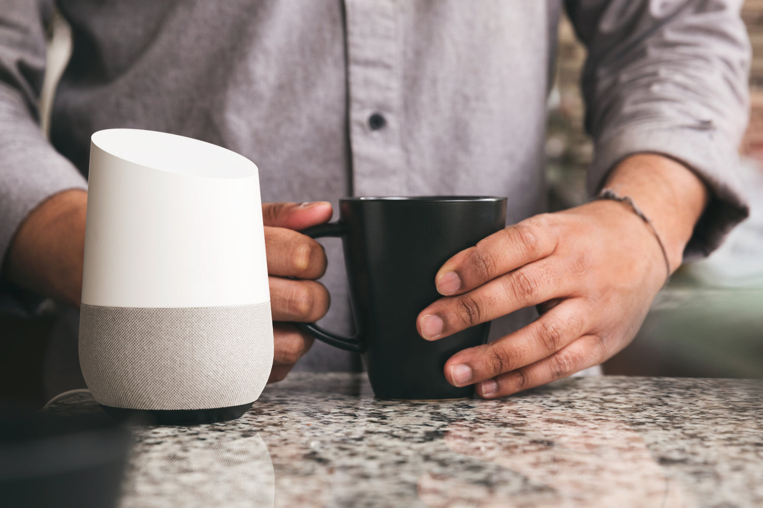 Coffee cup beside a smart-home control device on a kitchen counter