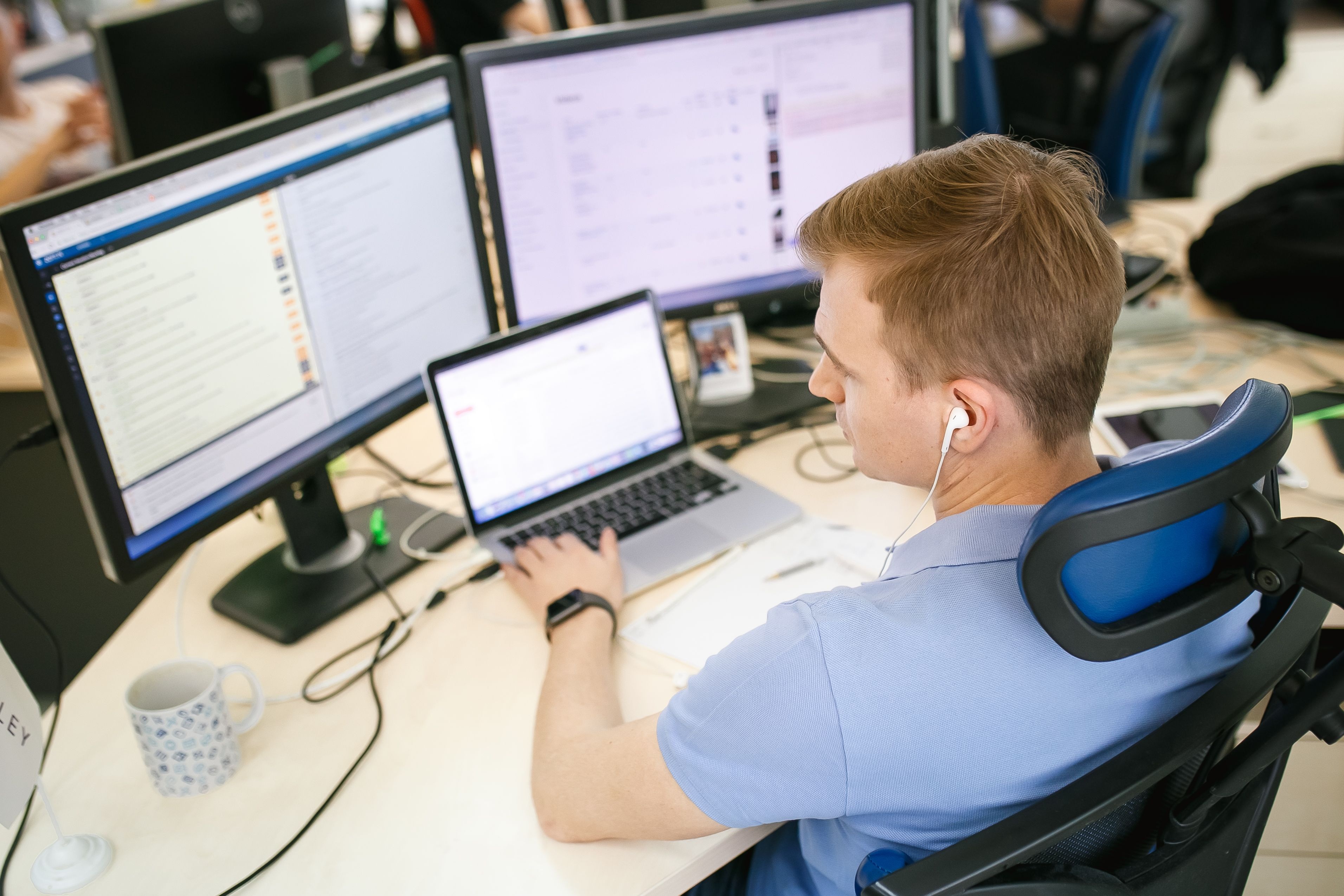 A Waverley team member working at a desk with several screens
