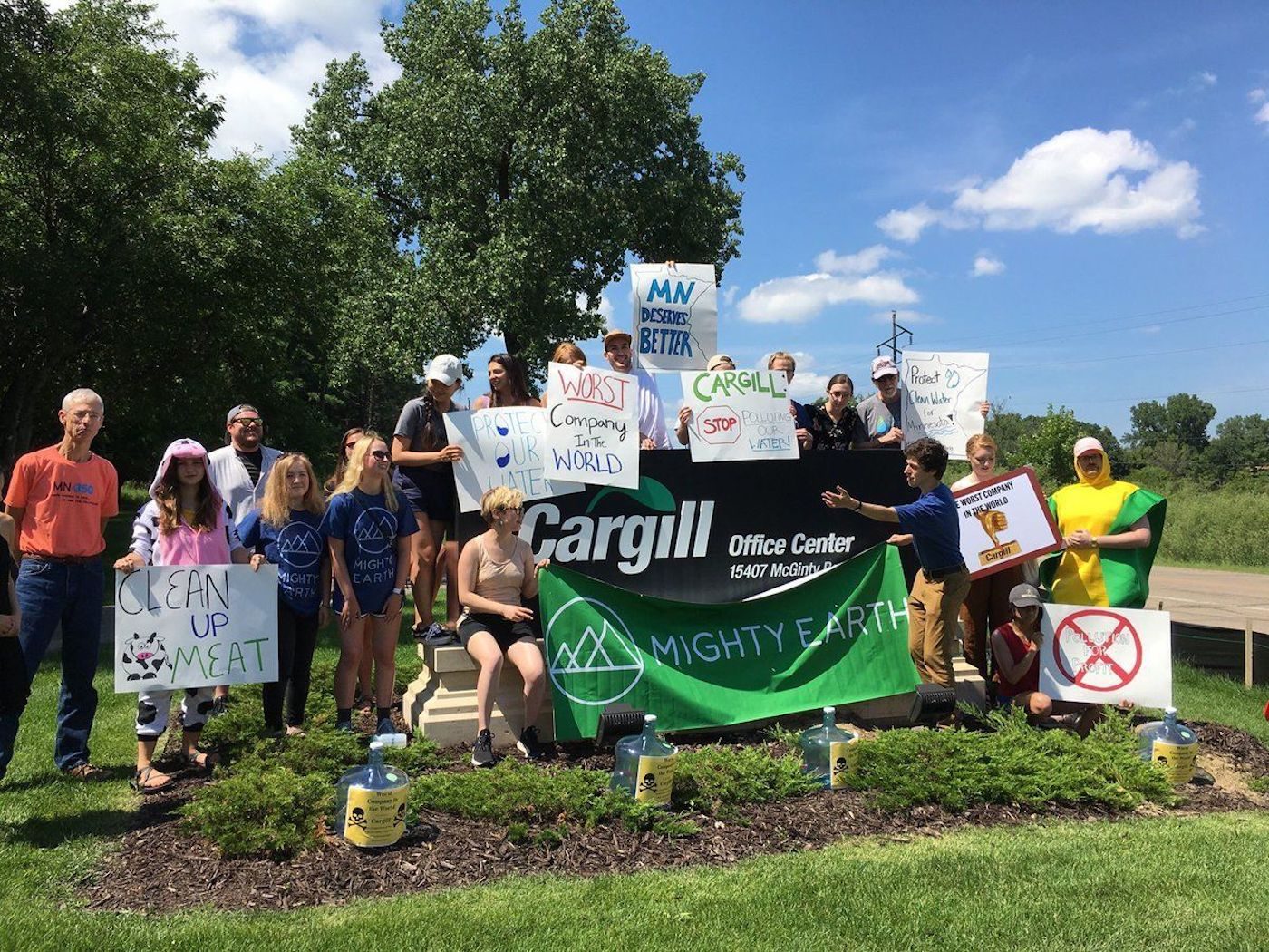 Mighty Earth campaigners holding signs outside a Cargill office
