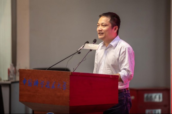 Wayne Huang speaking at a lectern at the University of Science and Technology of China in September 2020