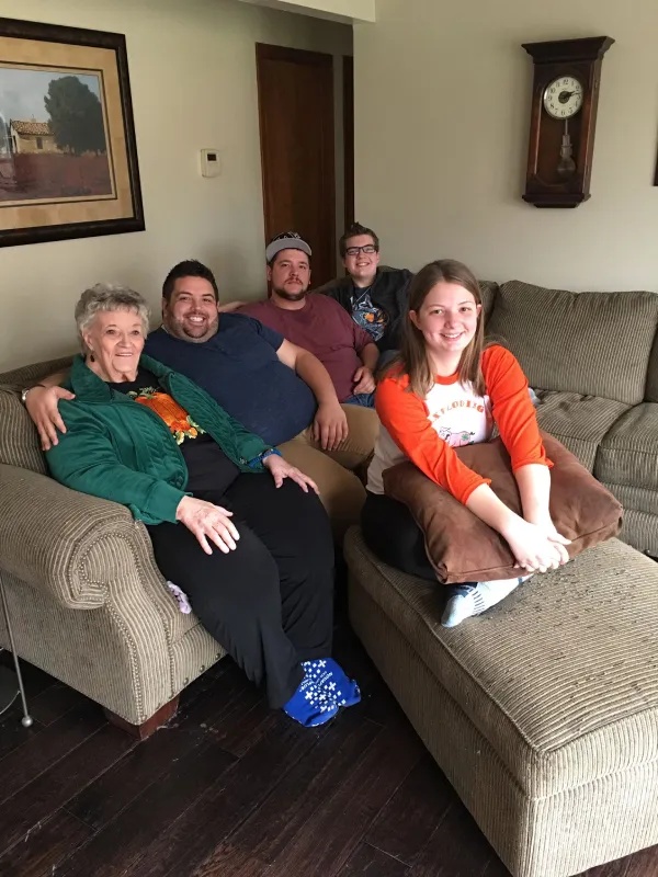 Wayne Stanley sitting with his grandmother and family