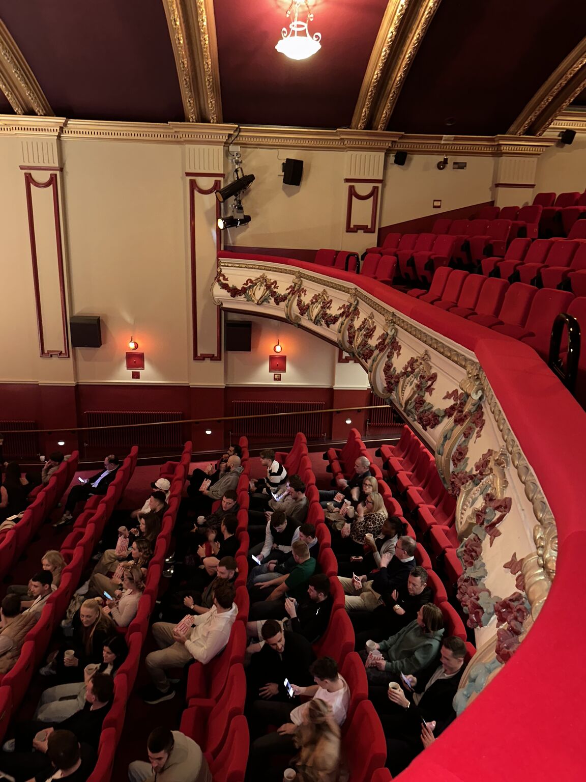 Colleagues seated in a red and gold cinema auditorium at the Back in Focus event