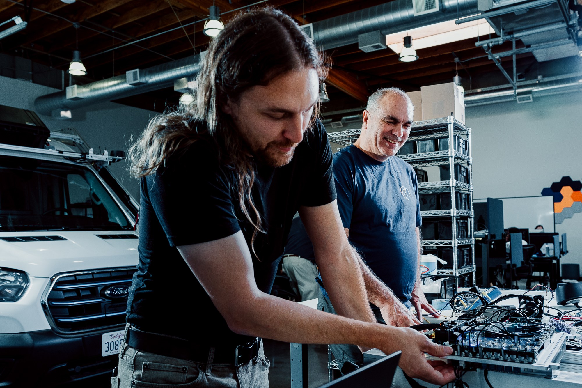 Wayve engineers working together around computer screens