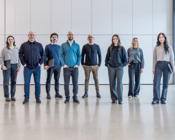Eight members of the WBM Technologies Saskatoon team standing in a bright office