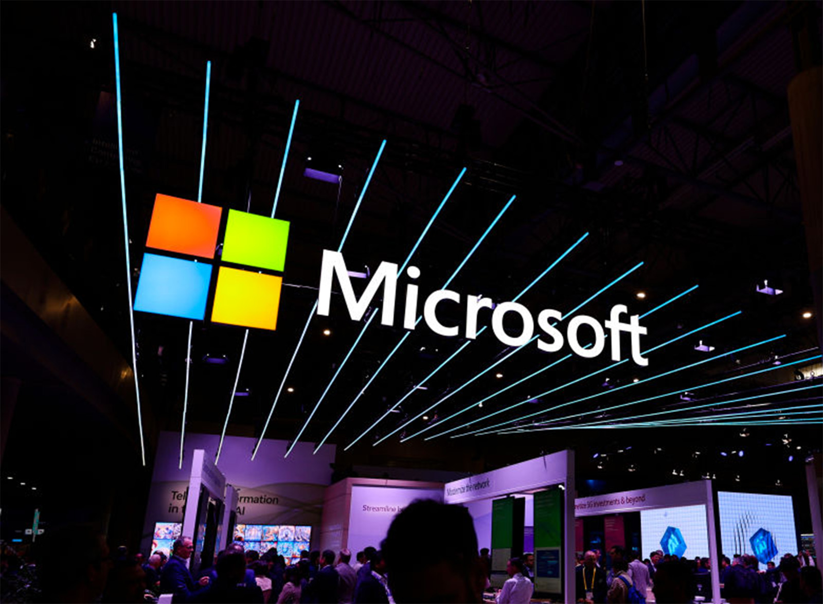 Microsoft signage above a busy technology event floor