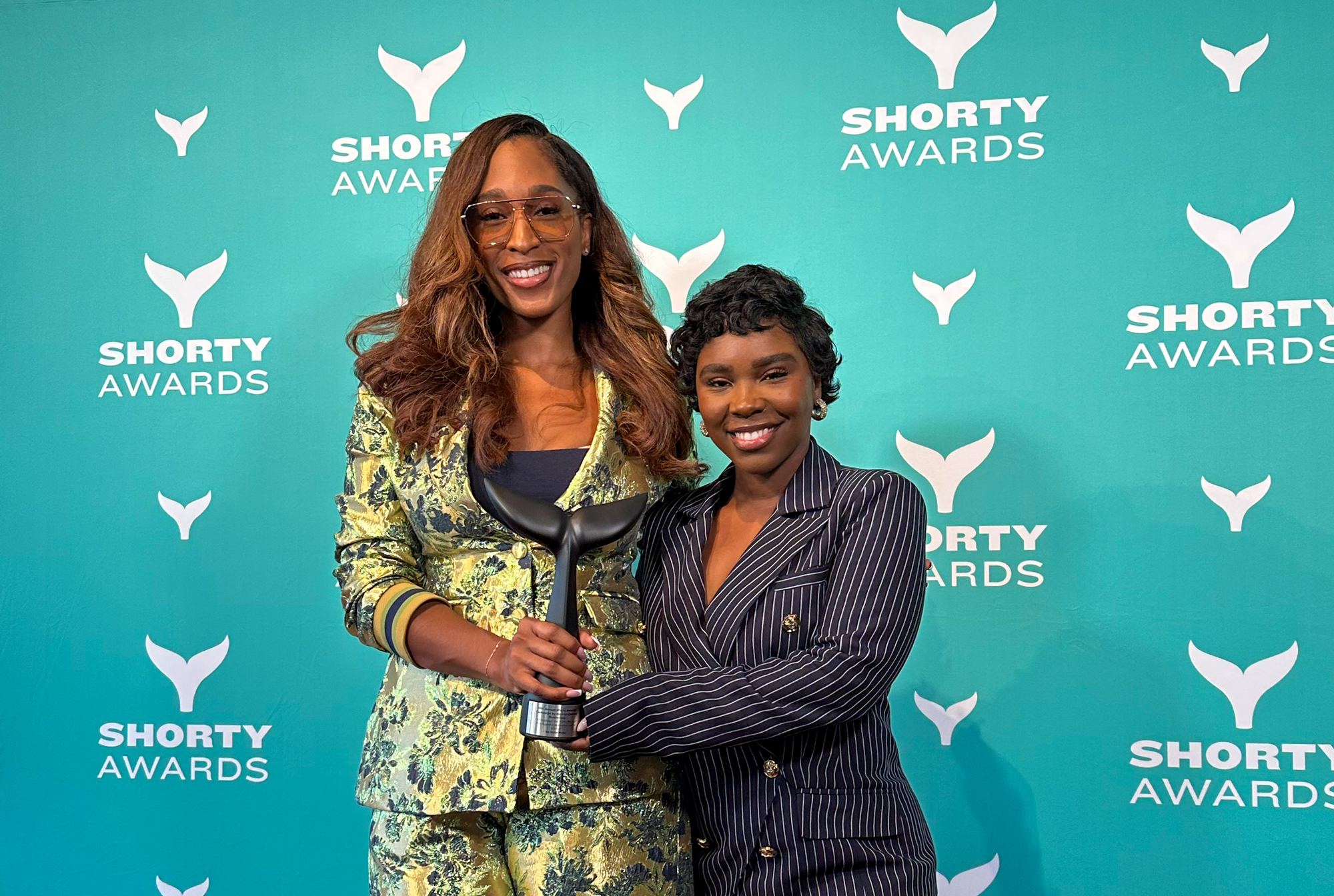 We Thrive Media founder Noelle Jones Aladesuyi and strategy director Nia Testamark holding a Shorty Award