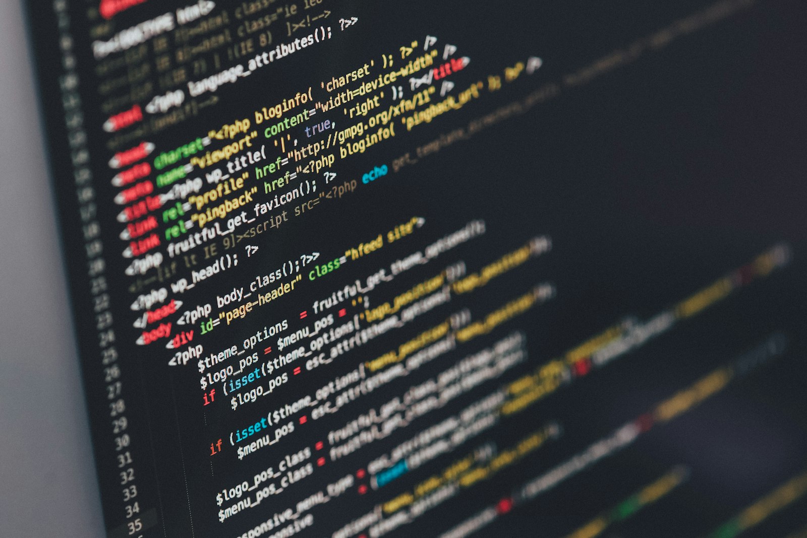 Lines of website markup and stylesheet code on a dark screen
