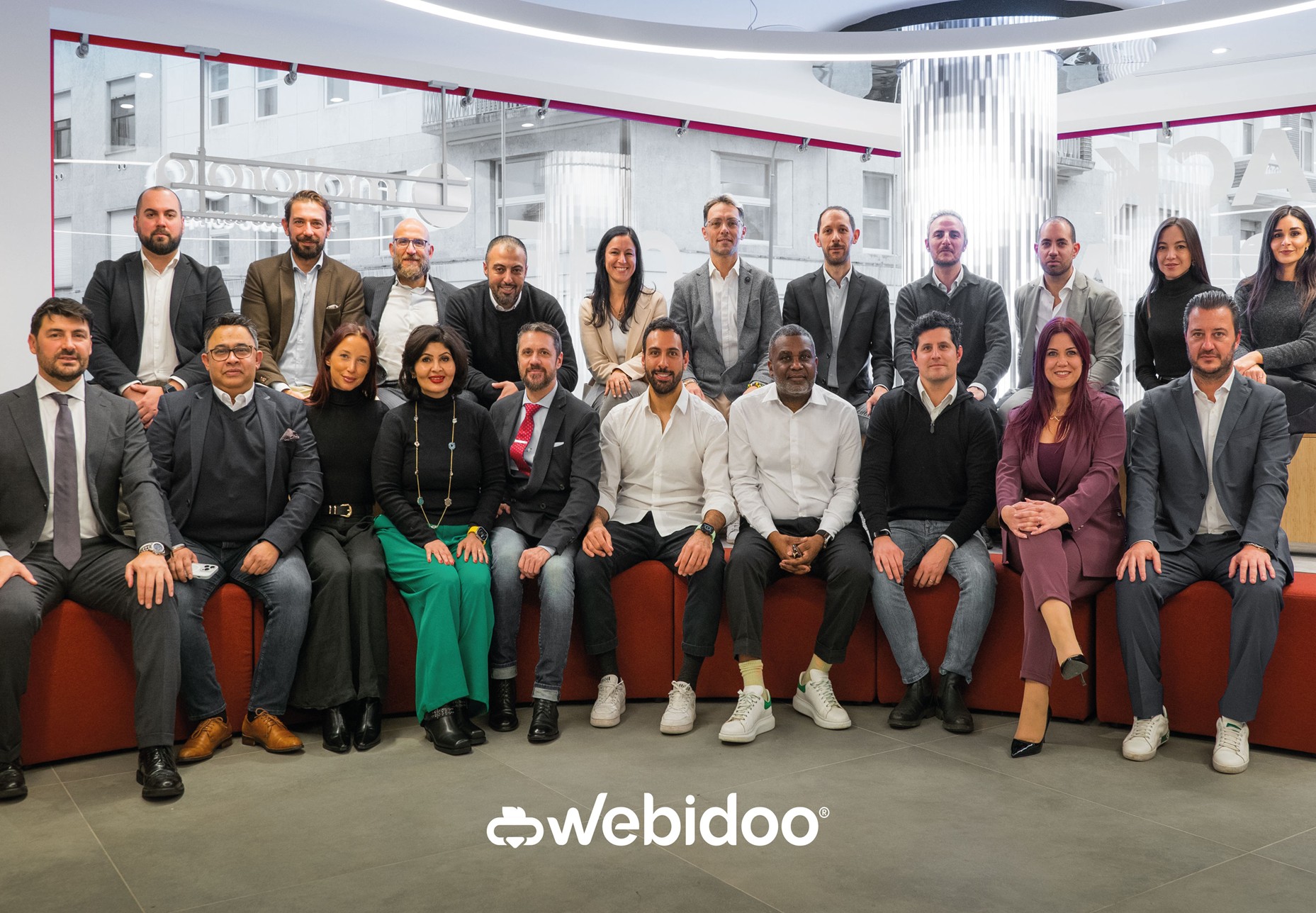 Webidoo leadership team gathered in a bright office