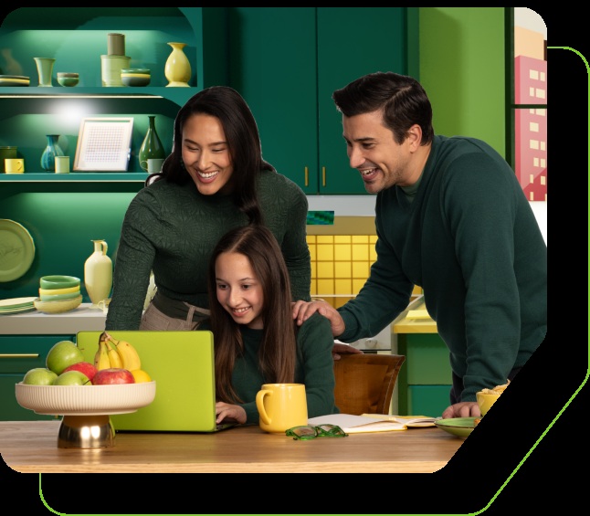 Webroot promotional photograph of a family gathered around a green laptop in a kitchen