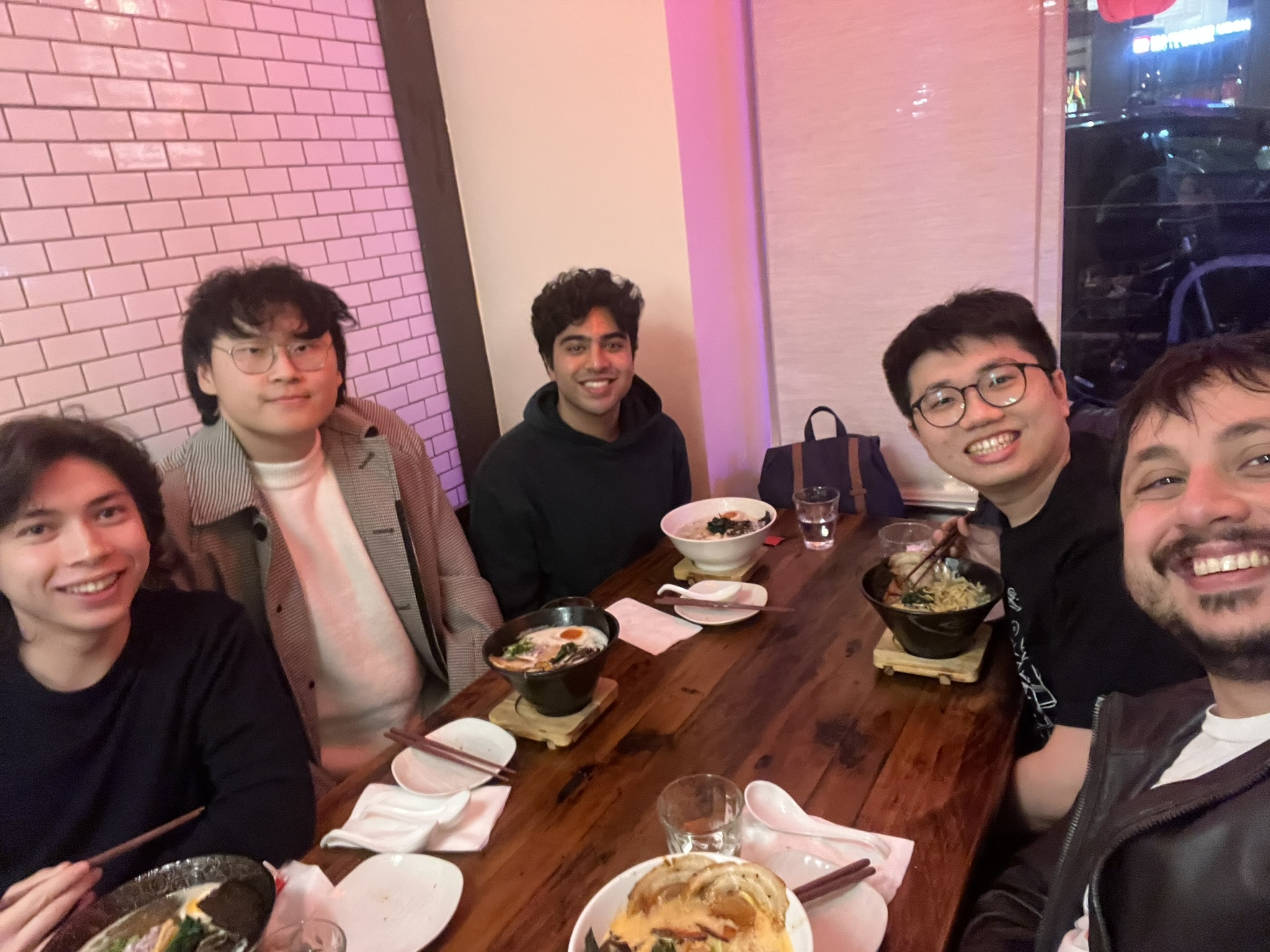 Wei-Lin Chiang with Anastasios Angelopoulos and Berkeley student collaborators around a restaurant table