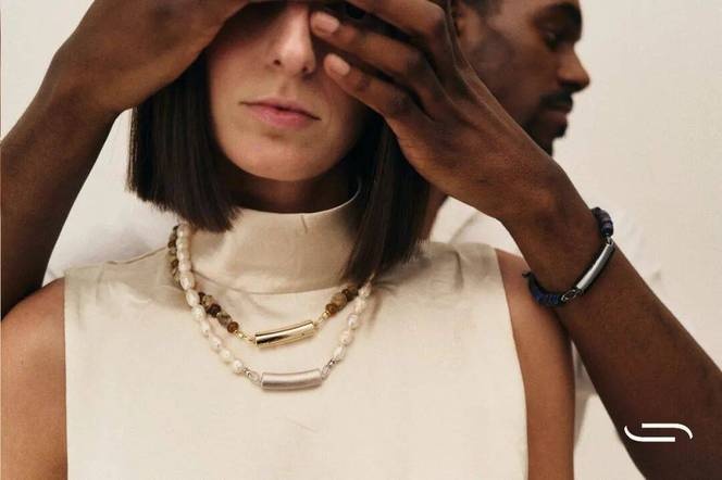 Nirva necklaces layered with pearl jewelry and a matching bracelet in a campaign photograph