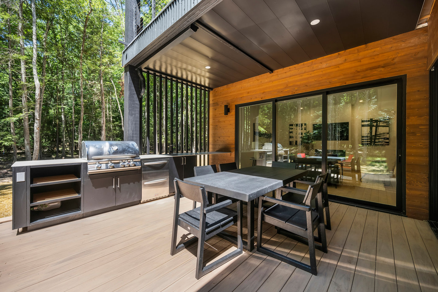 Covered outdoor kitchen and dining deck at a Welcome Homes Oasis 3 Flex home in Woodstock, New York
