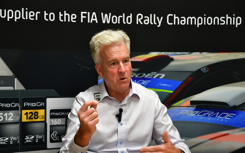 Wes Brewer holding a memory card during his Rally Japan interview
