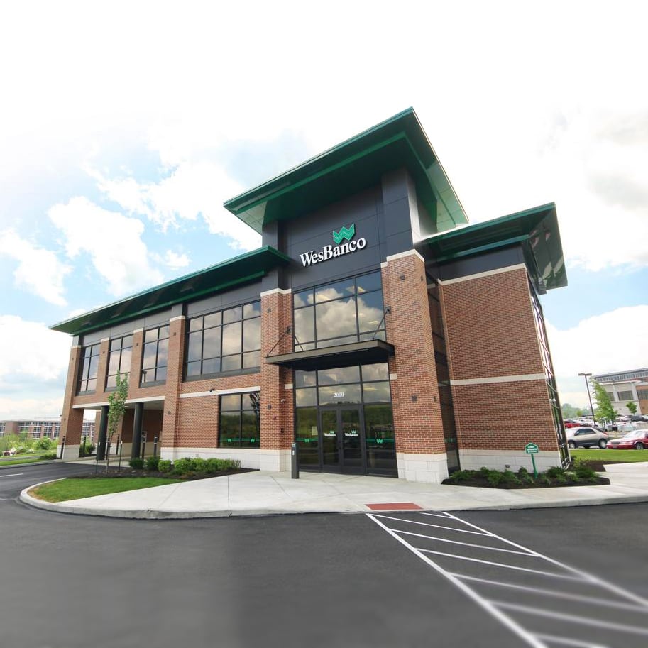 A WesBanco banking office with brick walls, glass windows and green rooflines
