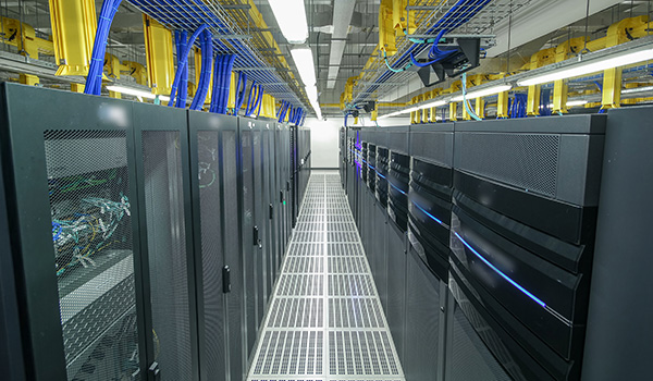 Rows of server cabinets in a data center, pictured on Wesco’s data center solutions page